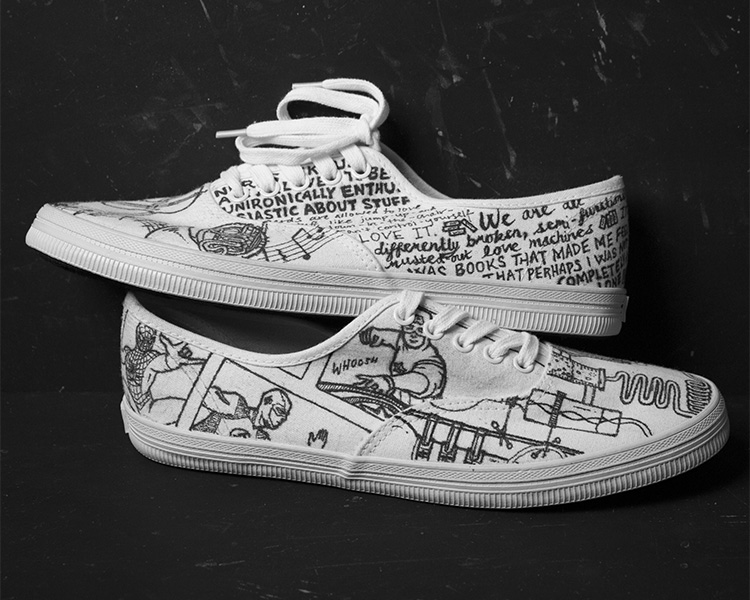 White Converse shoes with black illustrations of assorted objects  (side view)