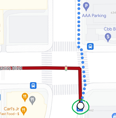 Screenshot of a navigation app showing a route starting at a bus stop on the south side of the street