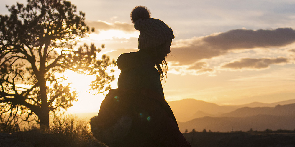 Silhouette of young woman during sunset